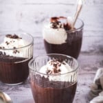 Three bowls of easy chocolate pudding with whipped cream.