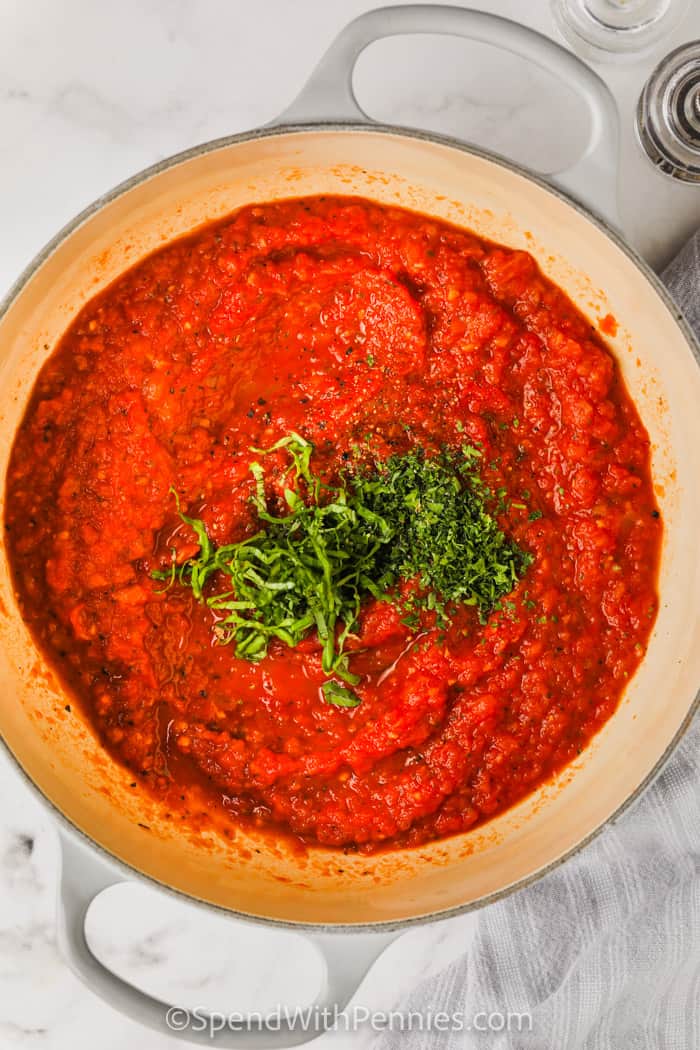 adding ingredients to pan to make Fresh Tomato Sauce